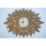 An early 20th century Smiths Electric sunburst wall clock having original electric movement with all