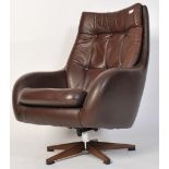 A vintage Scandinavian chocolate brown genuine leather swivel button back pod armchair with five