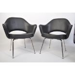 After Eero Saarinen, a pair of black faux leather and chrome upholstered ' executive ' side