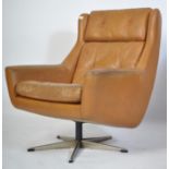 A retro 1960's mustard yellow leather swivel armchair of angular form being raised on a chrome 5