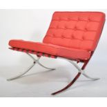 A contemporary Barcelona chair after the original by Mies van der Rohe being upholstered in red