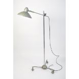 A floorstanding full size Sollux Industrial lamp raised on a spider leg base with ball wheel castors