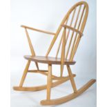 An Ercol 20th century blond wood retro rocking chair in the windsor pattern. Sleigh runners with