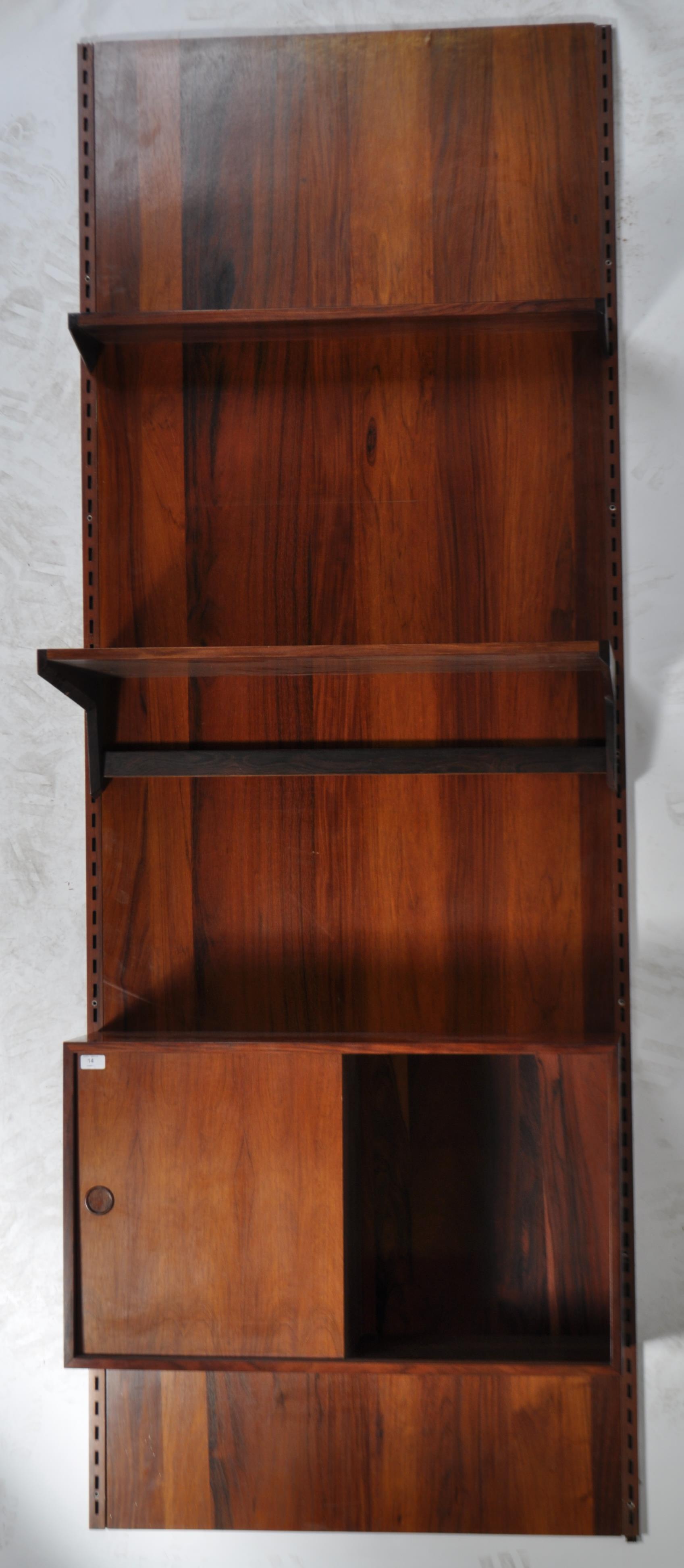 A rare mid century Danish rosewood modular wall system having a large rosewood panel back with