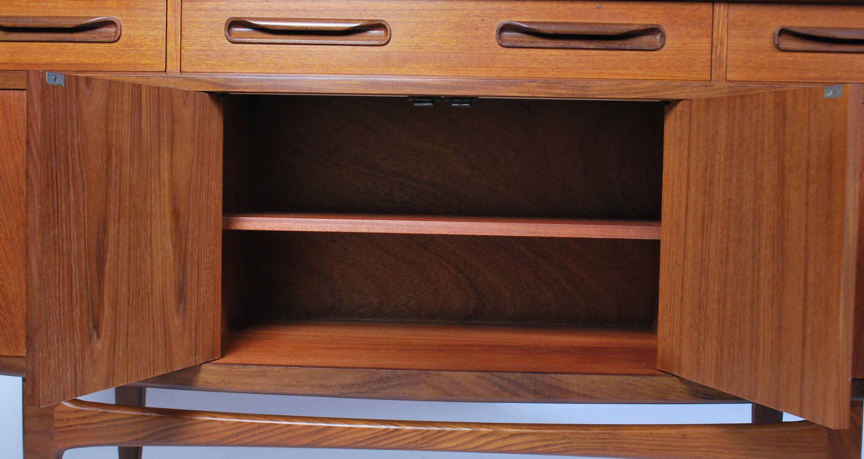 A 1970's retro G-Plan ' Fresco ' pattern teak wood sideboard being raised on tapered supports having - Image 4 of 6