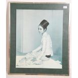 A mid century retro mounted print of a Malaysian girl in robes being signed by the artist with