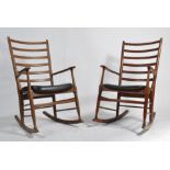 A rare pair of 1960's Danish teak wood rocking chairs being raised on turned supports with sleigh