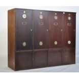 A large 20th century Industrial panel wood locker unit having multiple locker doors with vented