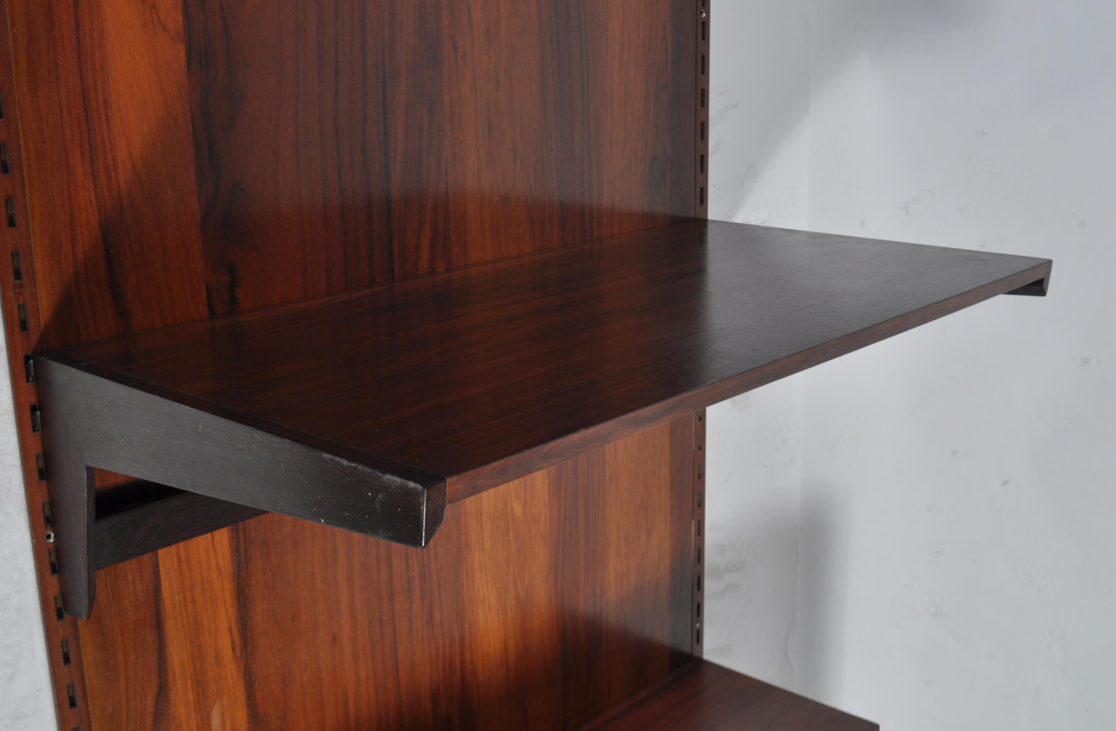 A rare mid century Danish rosewood modular wall system having a large rosewood panel back with - Image 6 of 10