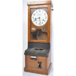 An early 20th century wall mounted mahogany cased National Time Recorder with circular dial set with