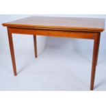 A good mid century Danish draw leaf teak wood refectory extending dining table having tapering