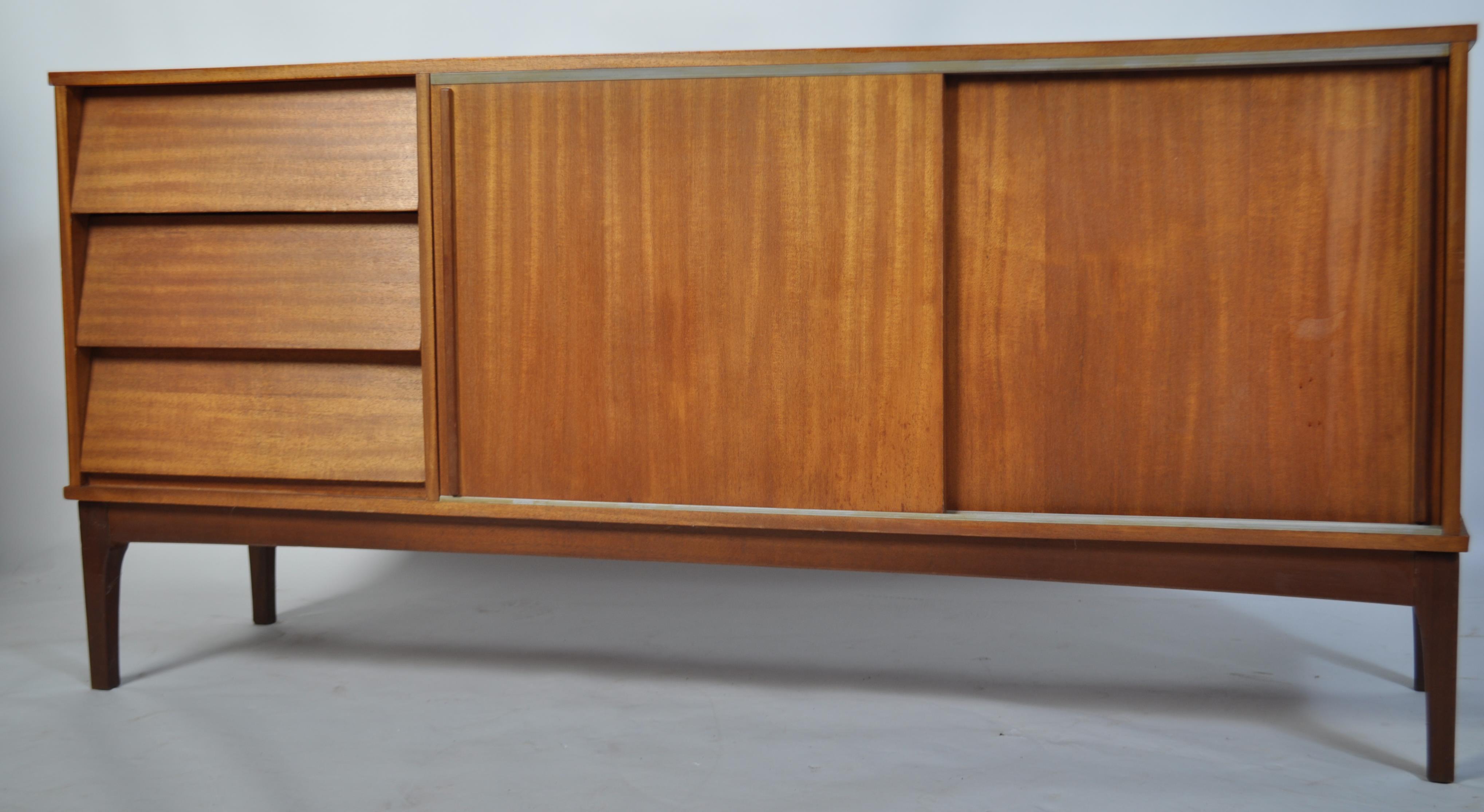 A retro mid century teak wood sideboard having a beehive angular facia comprising a series of