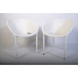 A pair of contemporary white plastic ' basket ' style chairs in the manner of Alessandro Busana.