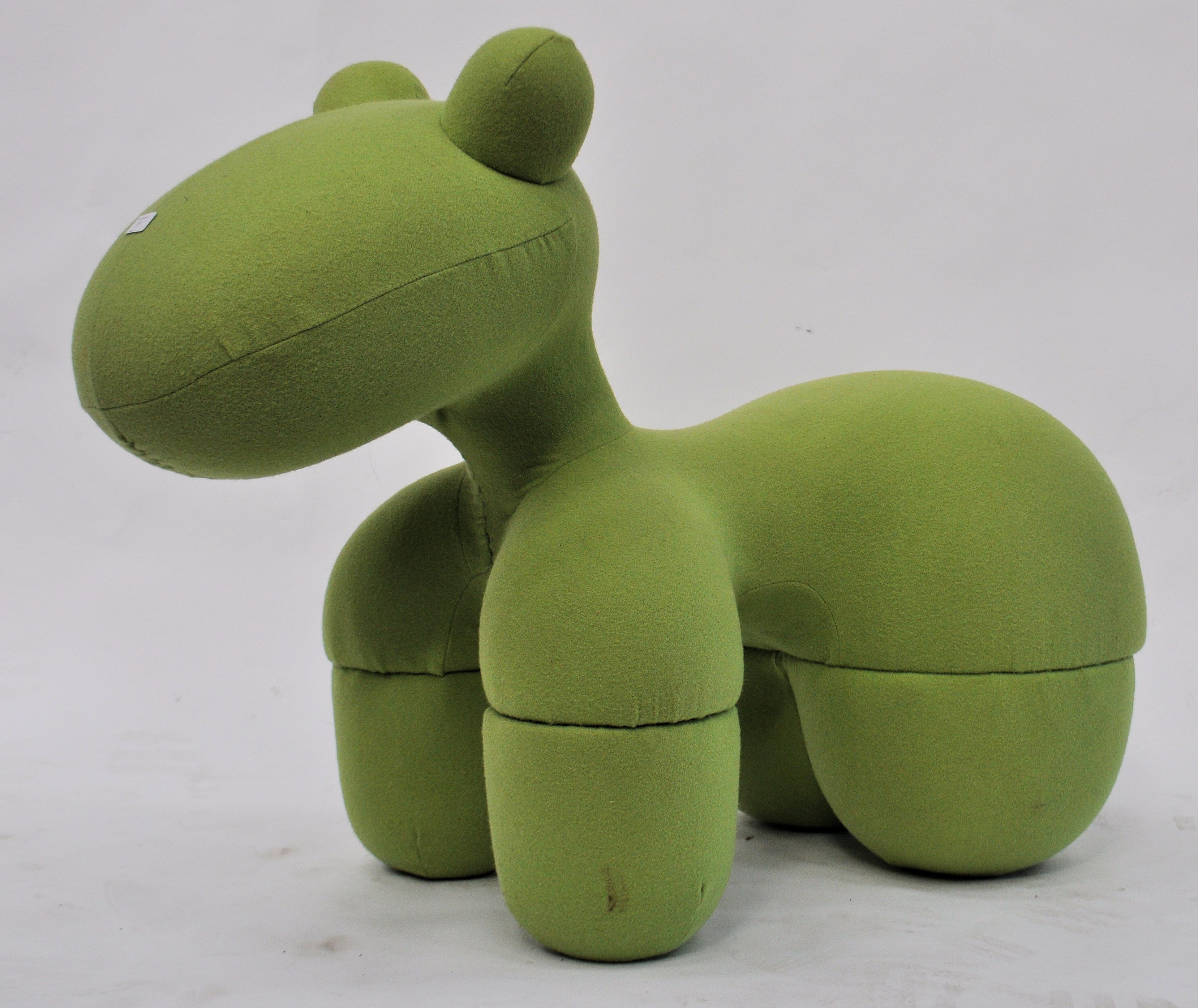 After Eero Aarnio, a 1970's pony chair stool - Giddy Up Pony being upholstered in a green fabric.