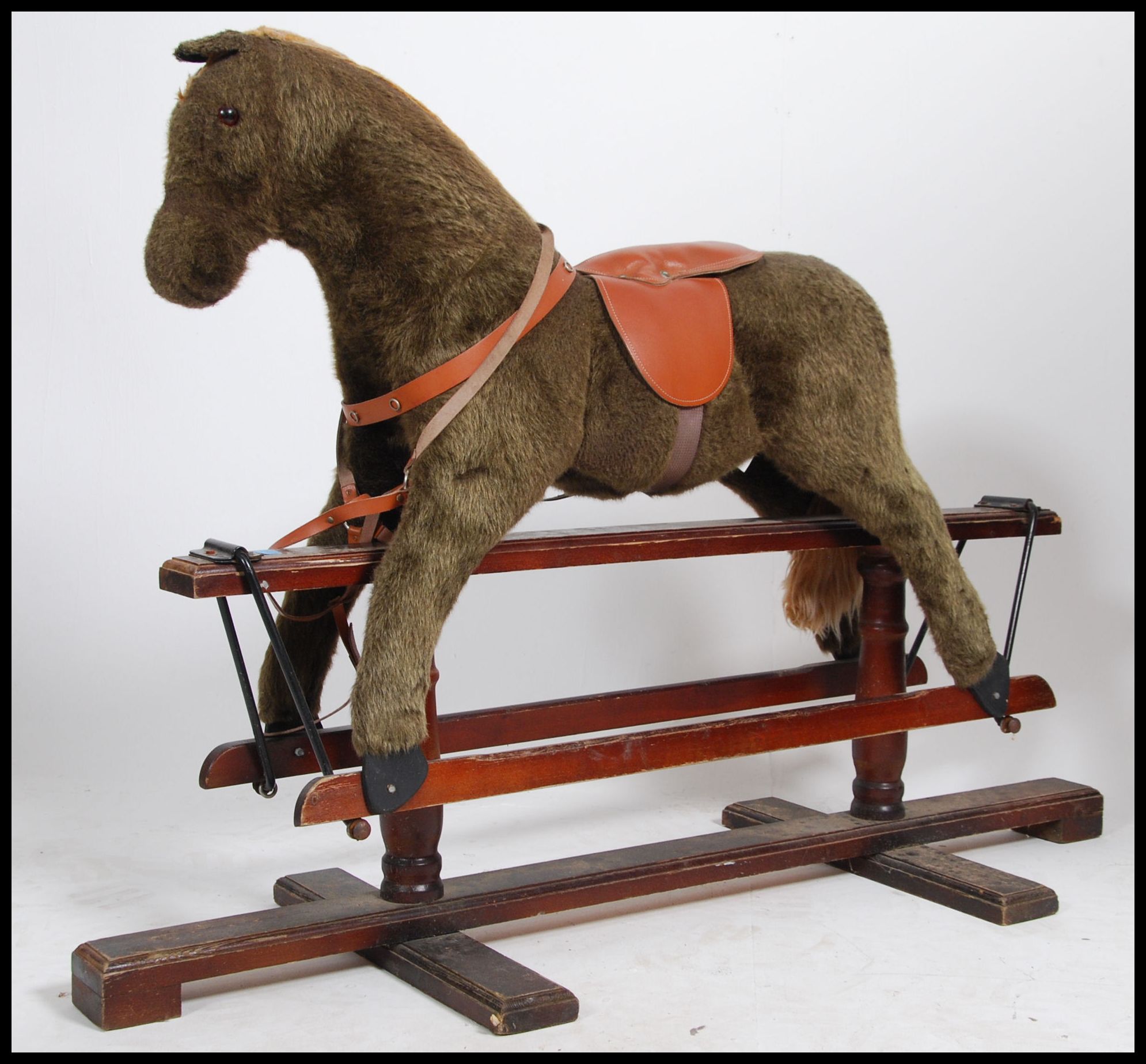 A 20th century Hadden style trestle rocking horse raised on a pine glider the body of the horse