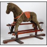A 20th century Hadden style trestle rocking horse raised on a pine glider the body of the horse