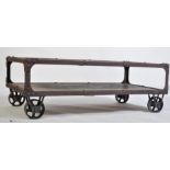 A vintage industrial style cart coffee table, having limed top and lower oak tiers with an iron