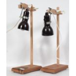A pair of mid century Industrial Laboratory / lab stands raised on wooden bracket supports with drop