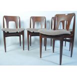 A set of 4 1950's teak dining chairs in the manner of Poul Volther raised on tapered legs with upper