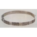 A sterling silver bangle bracelet of naturalistic