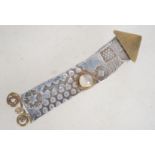 A vintage silver brass and moonstone rocket brooch