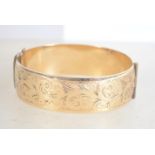 A heavy vintage 9ct rolled gold bangle being half