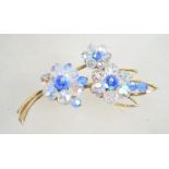 A vintage 1950s crystal flower brooch in a gold to