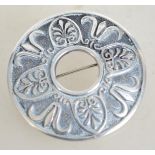 A sterling silver circular shield brooch having a