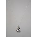 A silver pendant necklace with skeleton hand penda