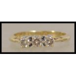 An 18ct gold 3 stone diamond ring. The 3 stones ap