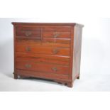 An Edwardian  walnut cottage  chest of drawers wit