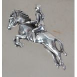 A silver brooch in the form of a leaping horse and
