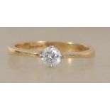 A hallmarked 18ct gold ring set with a single bril