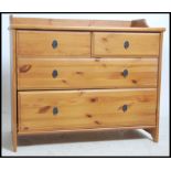 A contemporary pine 2 over 2 chest of drawers havi