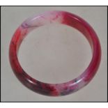 A Chinese Jade Bangle Bracelet, rose coloured ston