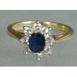 An 18ct gold sapphire and diamond ladies ring. The