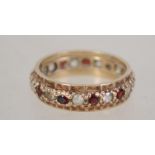 A hallmarked 9ct gold eternity ring set with red a