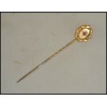 A 9ct gold vintage stick / hat pin having inset ru