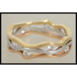 An 18ct  tri colour gold abstract band ring set wi