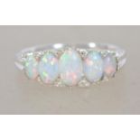 A silver five stone opal set ring. Size S.5. Total