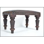 A Victorian Arts & Crafts leather footstool having