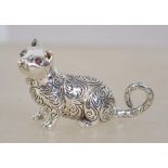 A cast silver figure of a cat with ruby eyes