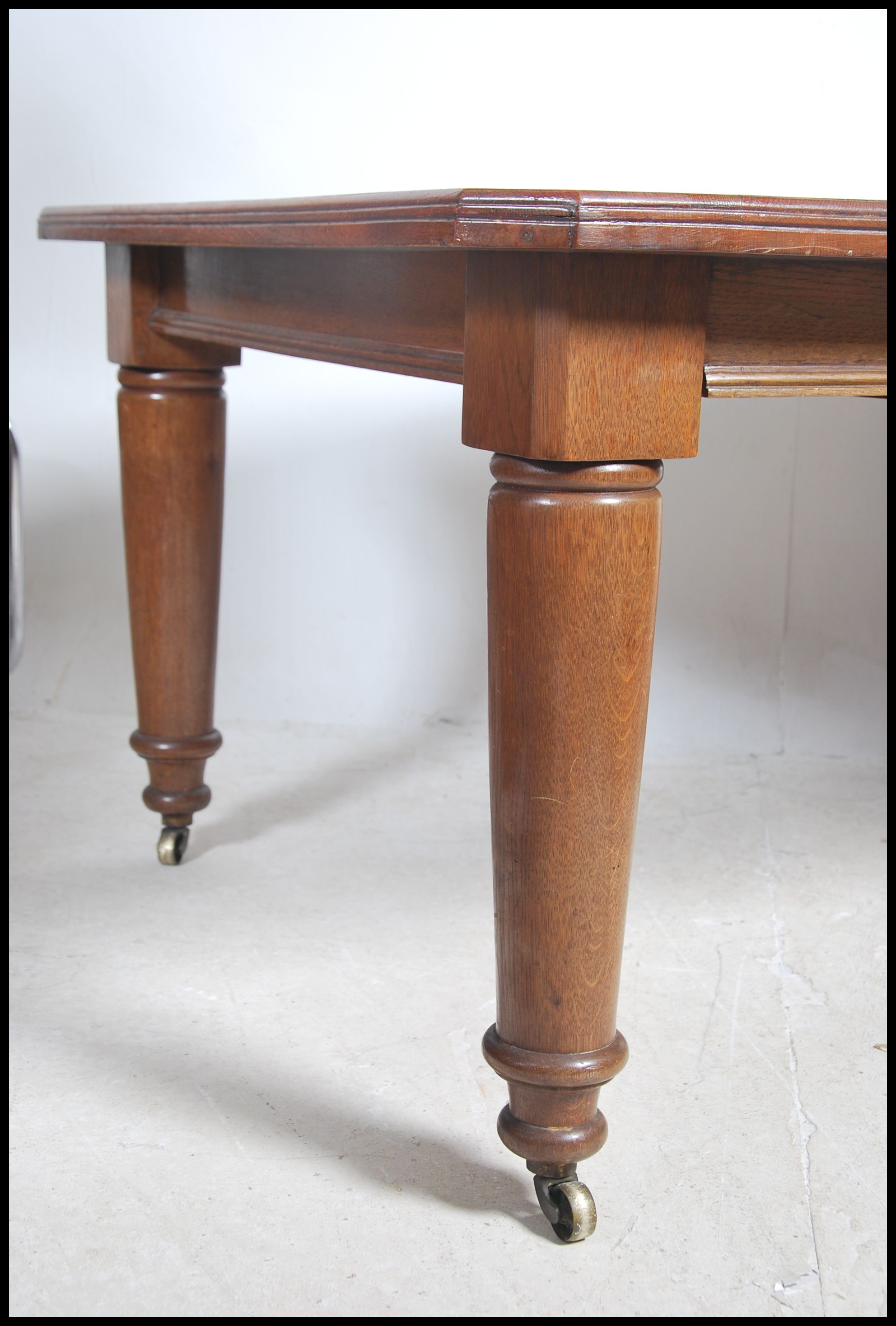 A large Victorian twin leaf wind out dining table - Image 3 of 5