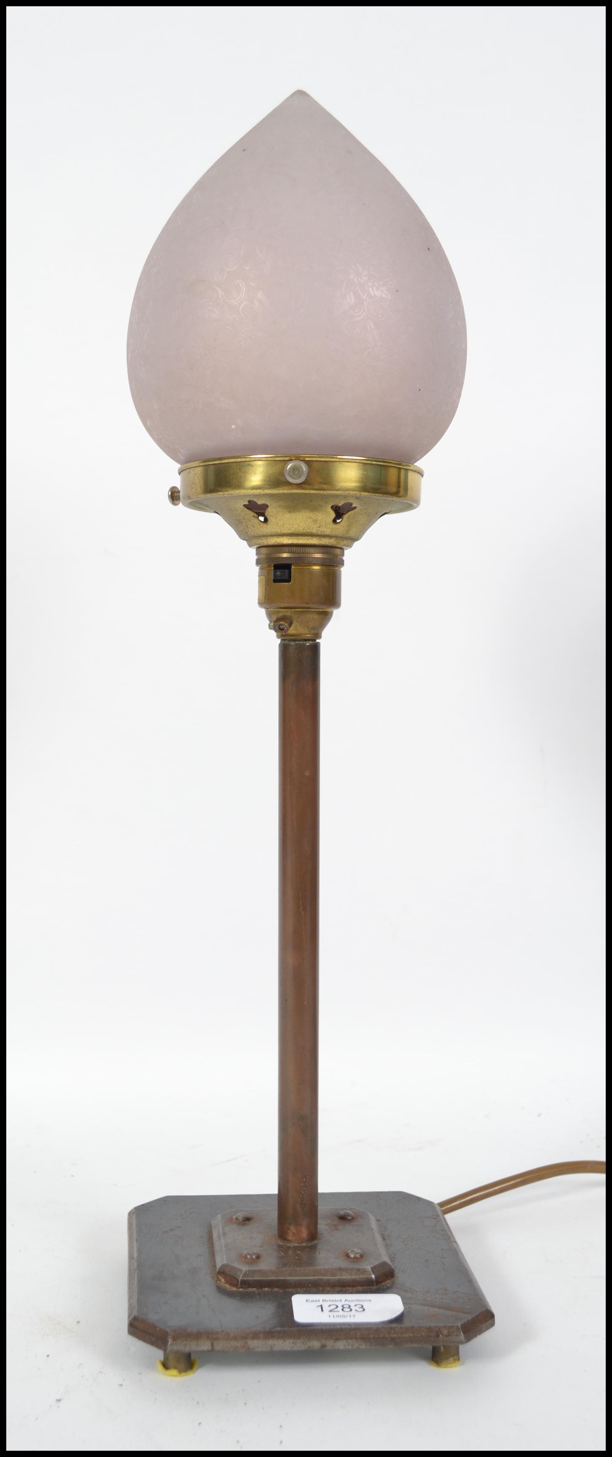 A 20th century Art Deco copper lamp on a two tier
