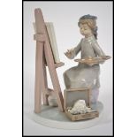 A Lladro seated figurine of a girl painting / arti