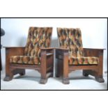 A pair of 1930's Art Deco oak reclining armchairs.