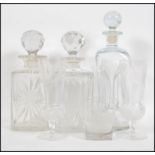 A collection of three glass decanters and stoppers