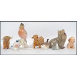 A collection of ceramic animal figurines to includ