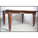 A large Victorian twin leaf wind out dining table