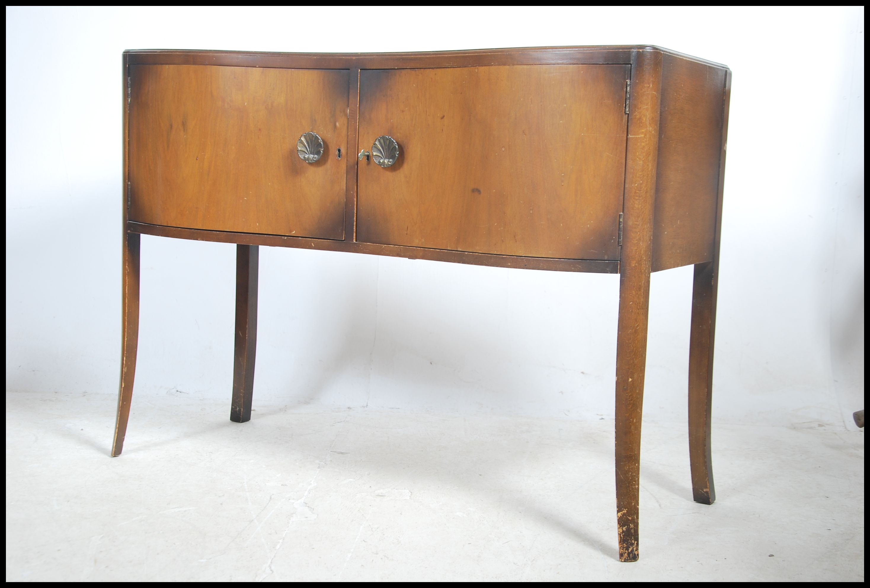 A 1950's post war Art Deco sideboard raised on ser